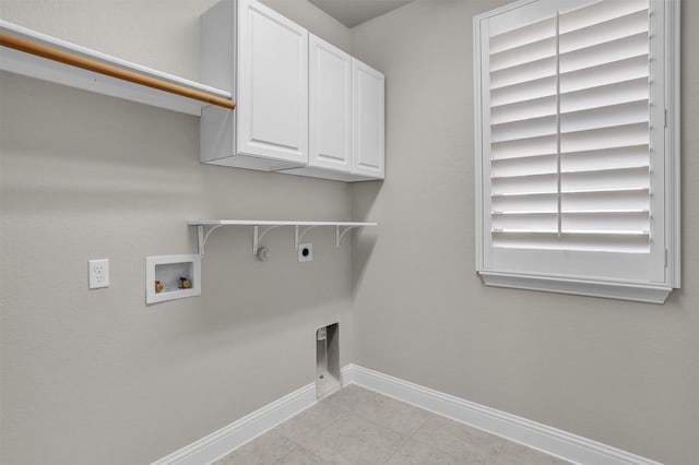 laundry room featuring hookup for a gas dryer, washer hookup, baseboards, cabinet space, and electric dryer hookup