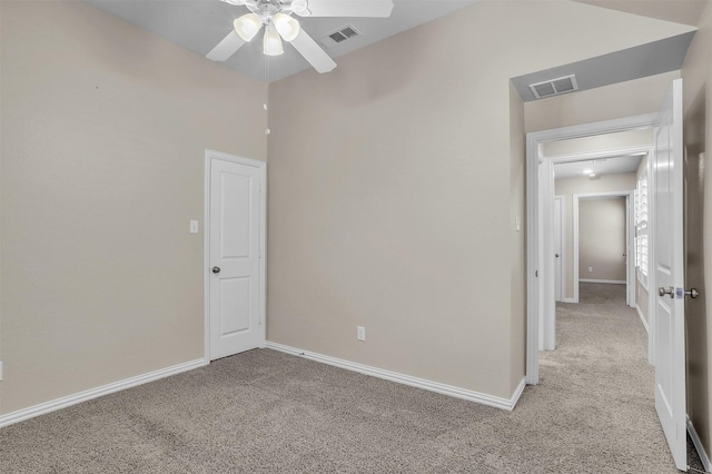 empty room featuring baseboards, visible vents, and light colored carpet