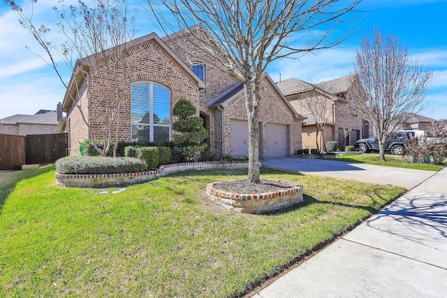 view of front of house with brick siding, concrete driveway, an attached garage, a front yard, and fence