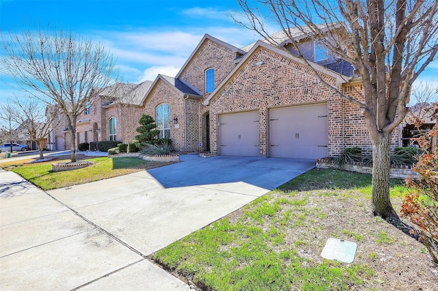 view of front facade featuring a front lawn, concrete driveway, brick siding, and an attached garage