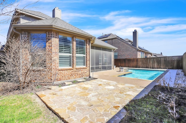 view of swimming pool with a patio area, a fenced backyard, a sunroom, and a fenced in pool