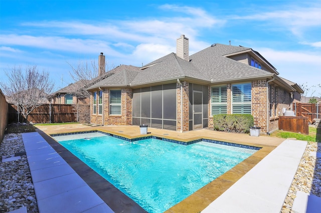 view of pool with a patio, a fenced backyard, a sunroom, and a fenced in pool