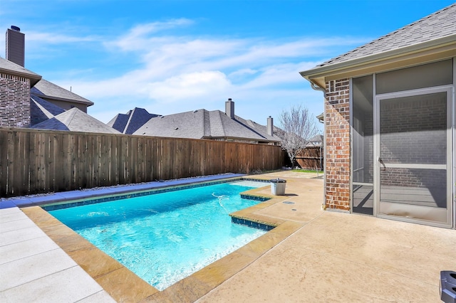 view of swimming pool featuring a patio area, a fenced backyard, and a fenced in pool