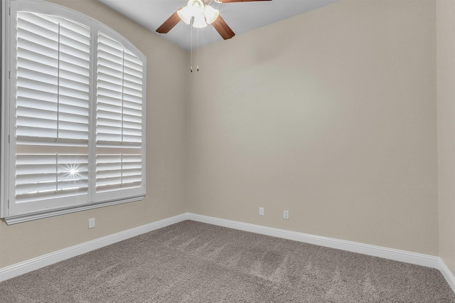 spare room with carpet, baseboards, and ceiling fan