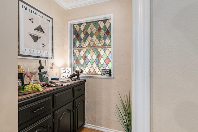 bar with a textured wall and ornamental molding