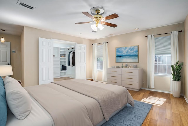 bedroom featuring light wood-type flooring, ceiling fan, visible vents, and recessed lighting