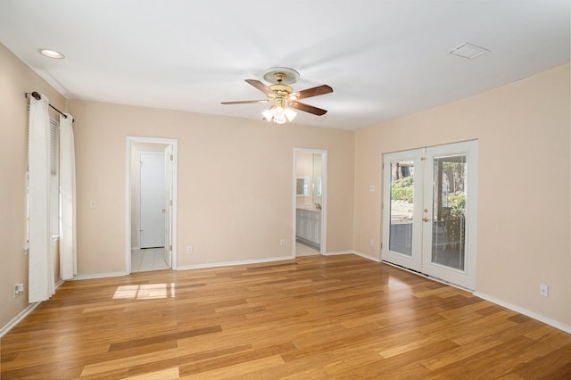 unfurnished room with baseboards, french doors, and light wood-style floors