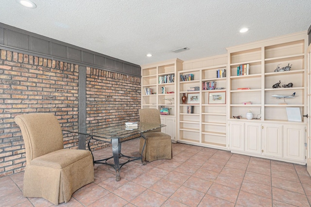 sitting room with recessed lighting, visible vents, light tile patterned flooring, a textured ceiling, and brick wall