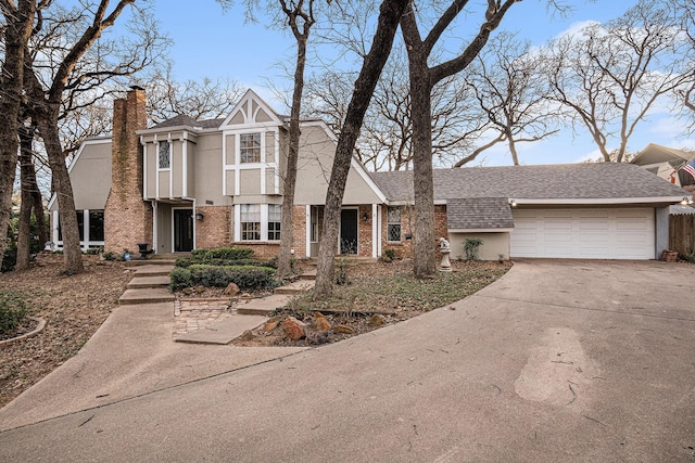 view of front of house with roof with shingles, a chimney, stucco siding, an attached garage, and driveway