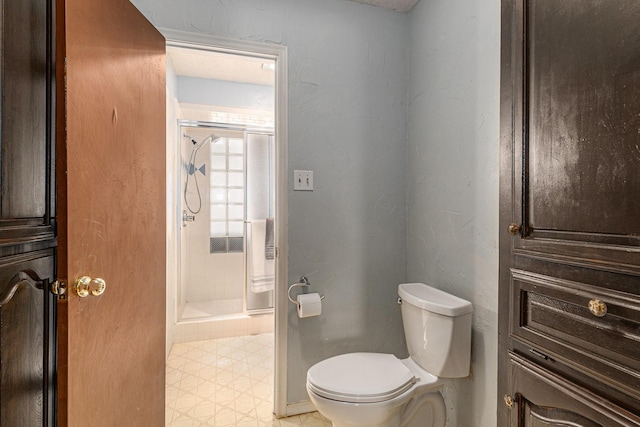 full bathroom with a shower stall, toilet, and tile patterned floors