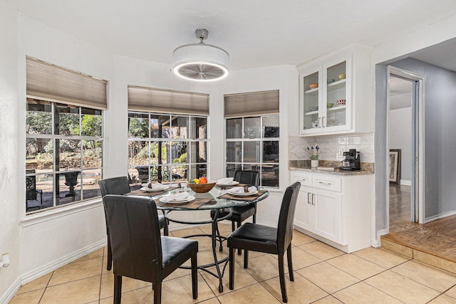 dining area featuring light tile patterned floors and baseboards