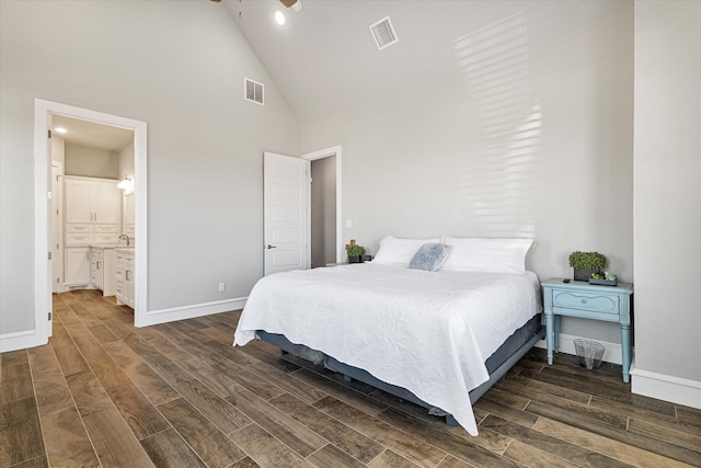 bedroom featuring high vaulted ceiling, baseboards, visible vents, and wood tiled floor