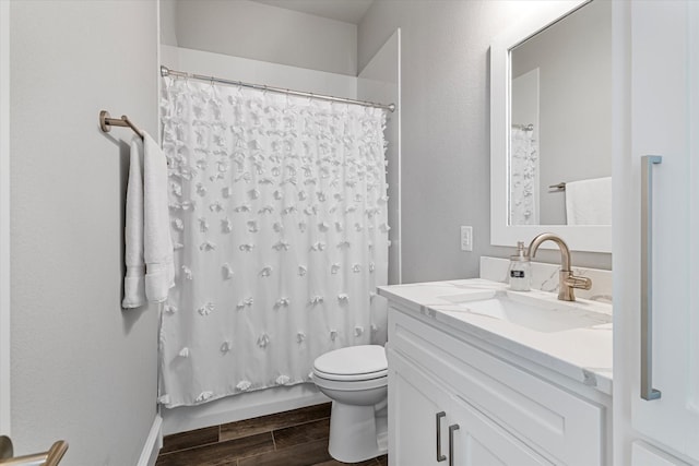 bathroom with shower / tub combo, toilet, vanity, and wood finish floors