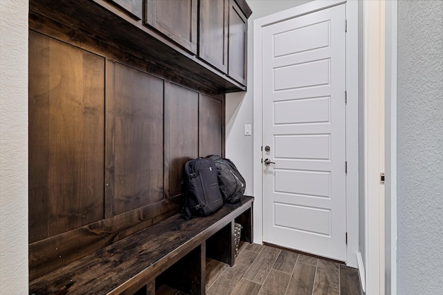 mudroom with a textured wall and wood finish floors