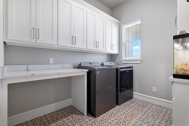 laundry area with light tile patterned floors, baseboards, cabinet space, and separate washer and dryer