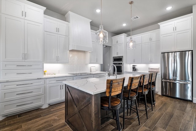 kitchen featuring dark wood finished floors, decorative backsplash, visible vents, and appliances with stainless steel finishes