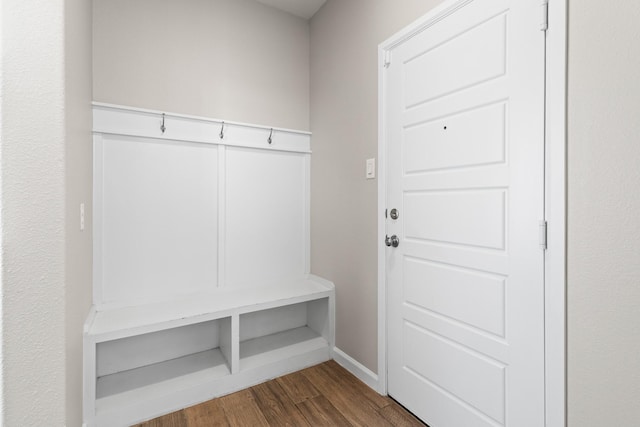 mudroom featuring dark wood-style floors and baseboards