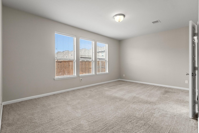 carpeted empty room with baseboards and visible vents