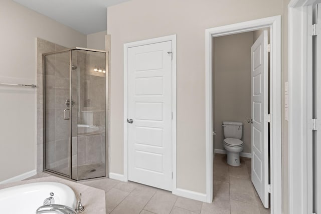 full bath featuring a tub to relax in, toilet, baseboards, a shower stall, and tile patterned floors