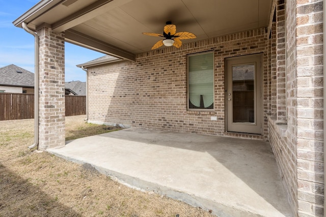 view of patio / terrace with ceiling fan and fence