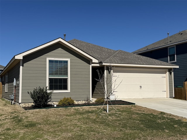 view of front facade with a garage, a front yard, driveway, and a shingled roof