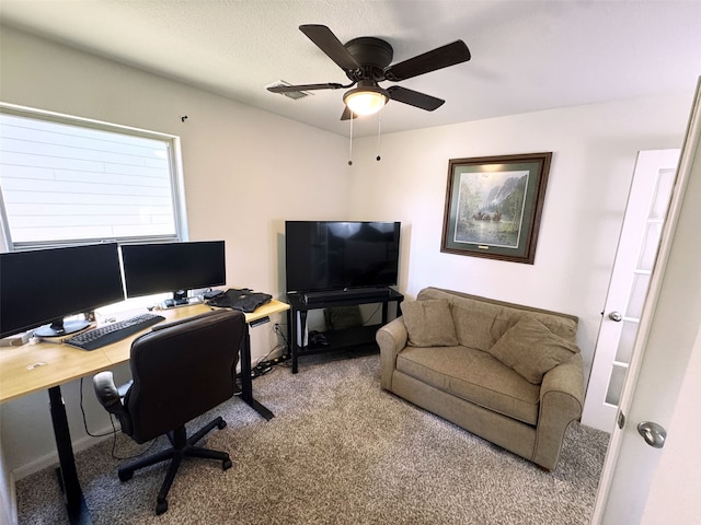 home office featuring visible vents, a textured ceiling, carpet flooring, and a ceiling fan