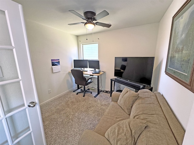 office space featuring carpet floors, ceiling fan, and baseboards