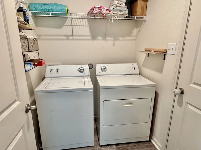 laundry area with laundry area, dark wood-type flooring, and washer and dryer