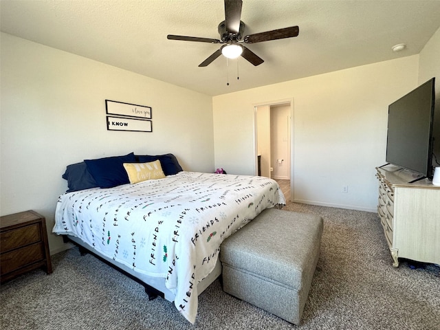 bedroom featuring baseboards, a ceiling fan, ensuite bathroom, carpet, and a textured ceiling