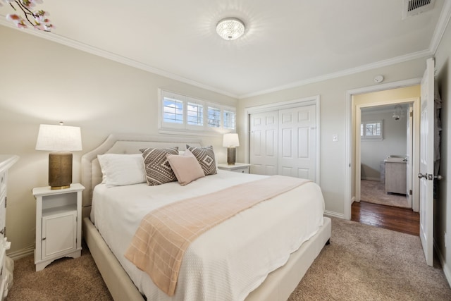 bedroom with multiple windows, visible vents, a closet, and ornamental molding