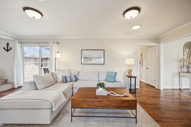 living area featuring baseboards, wood finished floors, and crown molding