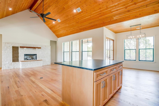 kitchen with visible vents, dark countertops, wood ceiling, open floor plan, and light wood-type flooring