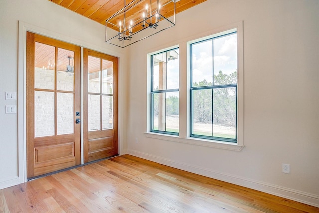 entryway featuring light wood-type flooring, plenty of natural light, baseboards, and french doors