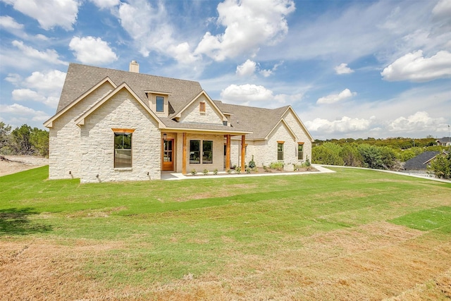 view of front of house with a front lawn, a chimney, and a shingled roof