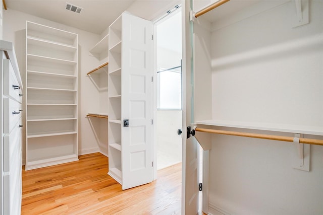 spacious closet with visible vents and light wood-style flooring