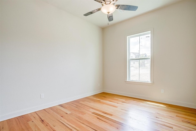 unfurnished room featuring a ceiling fan, light wood-style flooring, and baseboards