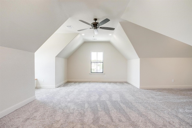 additional living space with a ceiling fan, lofted ceiling, light carpet, and baseboards