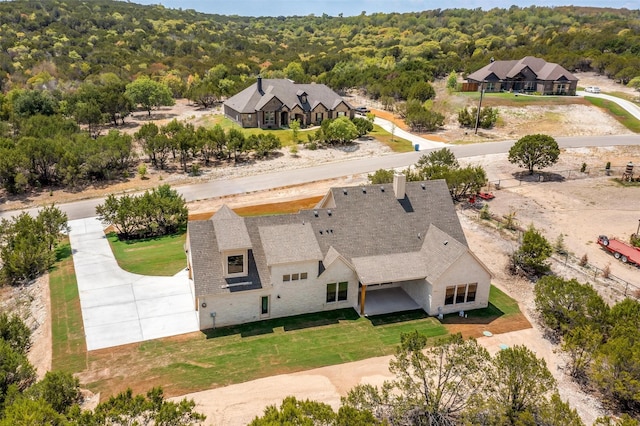 birds eye view of property featuring a view of trees