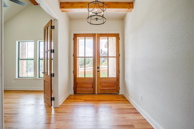 doorway featuring french doors, an inviting chandelier, light wood-type flooring, beamed ceiling, and baseboards