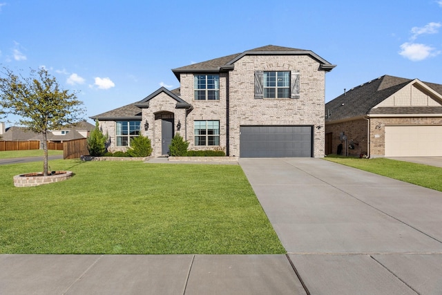 view of front of home featuring brick siding, fence, a garage, driveway, and a front lawn