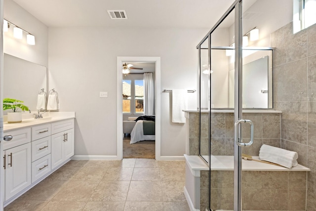 ensuite bathroom featuring visible vents, connected bathroom, vanity, a shower stall, and baseboards