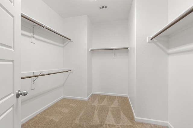 spacious closet with carpet floors and visible vents