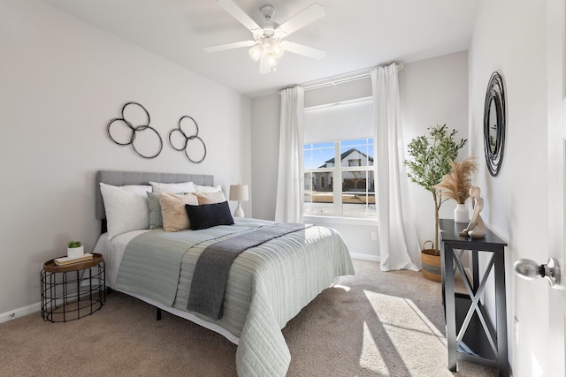 carpeted bedroom featuring ceiling fan and baseboards