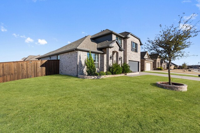 french country inspired facade with brick siding, fence, a garage, driveway, and a front lawn