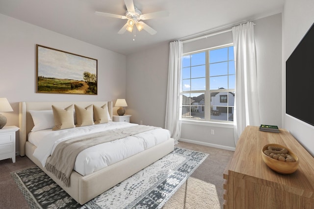 carpeted bedroom featuring baseboards and a ceiling fan