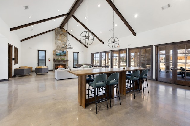 dining room with high vaulted ceiling, french doors, visible vents, and a fireplace