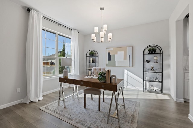 office featuring baseboards, wood finished floors, and a notable chandelier