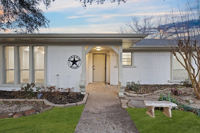 exterior entry at dusk with brick siding