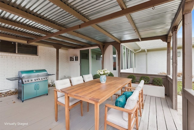 wooden deck featuring outdoor dining space and a grill