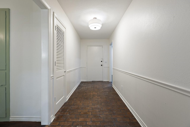 corridor with brick floor and wainscoting